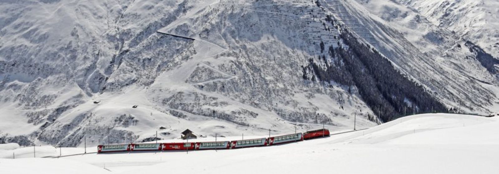 winter train journeys The Glacier Express Train in Switzerland going throug snowy mountains