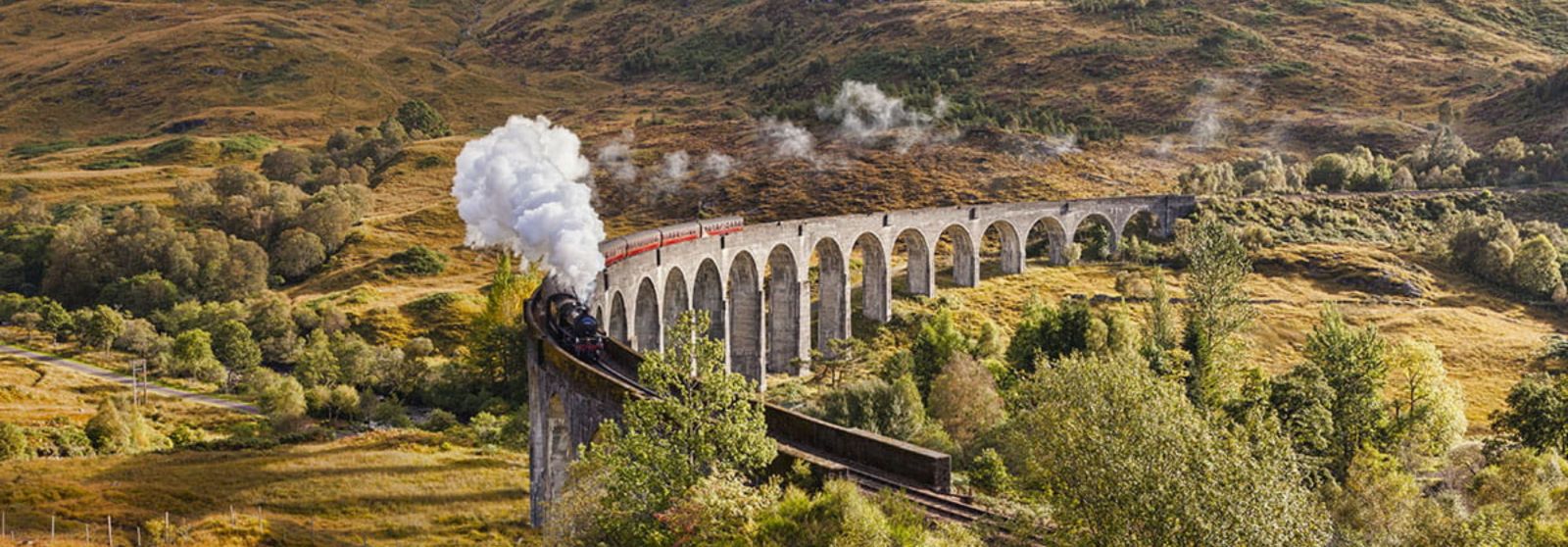 winter train journeys, The Jacobite Steam Train going over the famous Harry Potter Bridge in Scotland