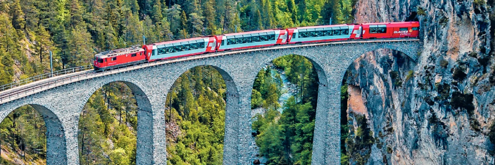 glacier express train passing over a bridge