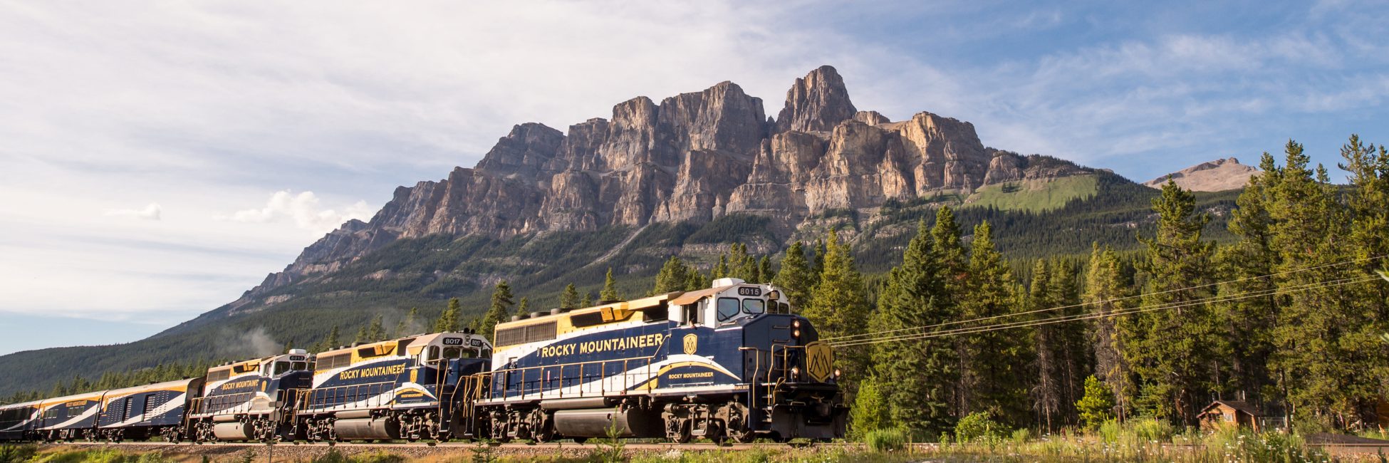 Rocky Mountaineer train journey passing in front of a mountain