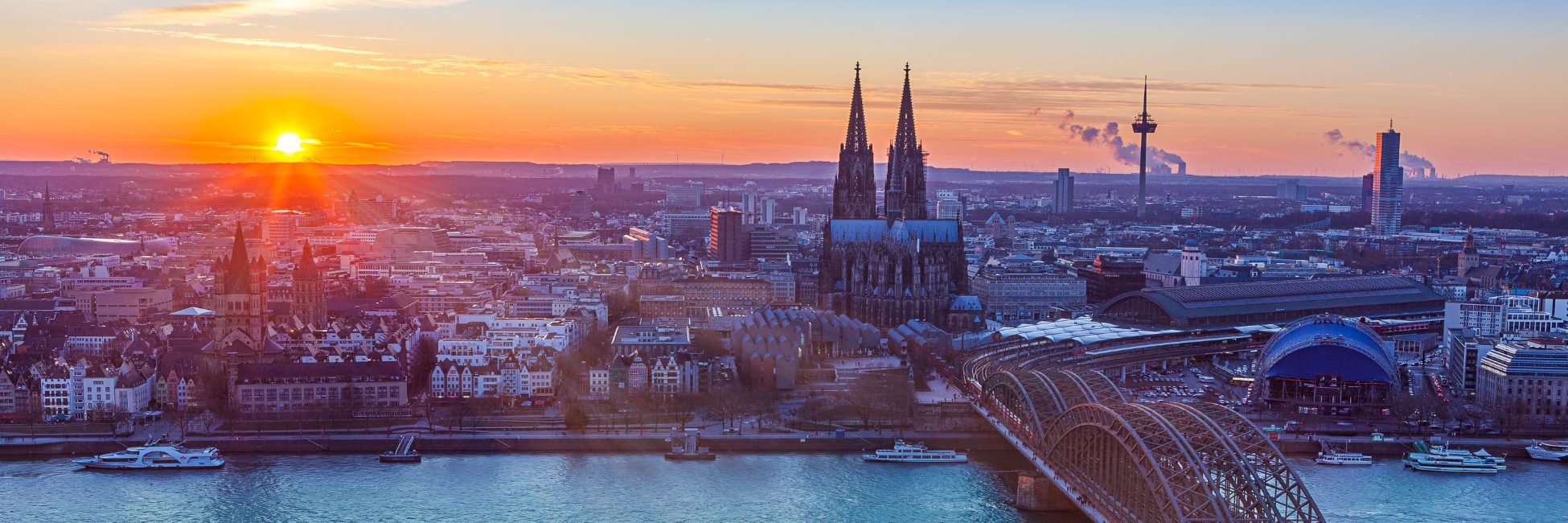 City views behind the river in the setting sun seen when exploring Germany by rail