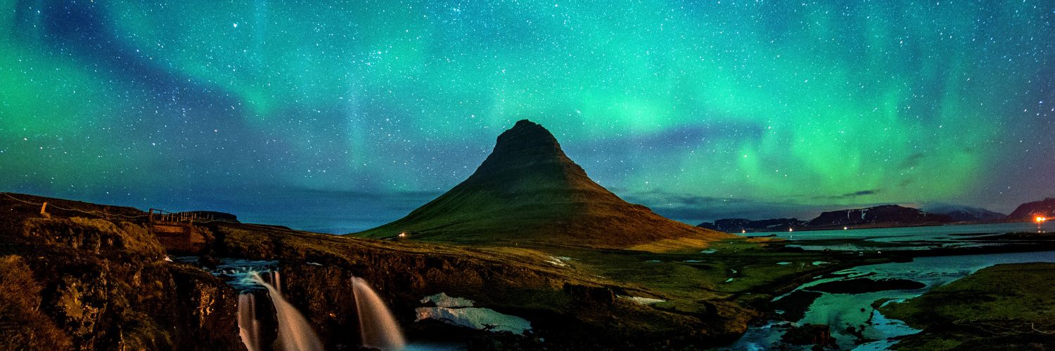 Mountain range with northern lights by rail
