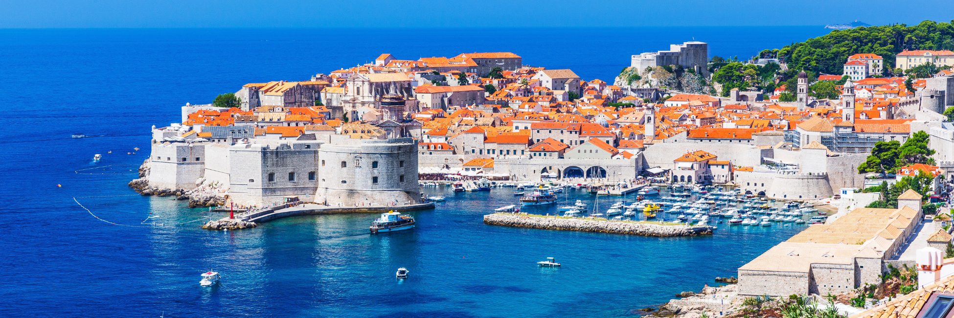 View of the coastline featuring terracotta- roofed houses, overlooking the sea, capturing the charm and scenery of a croatia rail holiday