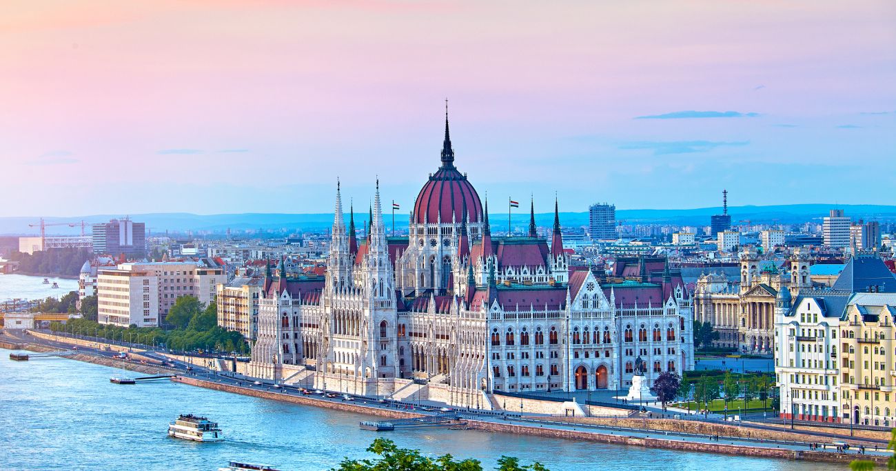 Budapest hungarian parliament building, standing impressively across the sunset