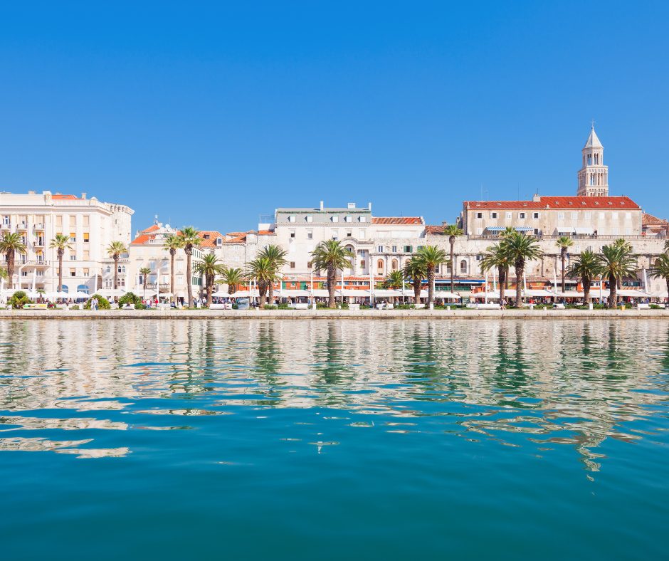 The still turquoise sea contrasts beautifully with the iconic sandstone buildings on a croatia rail holiday
