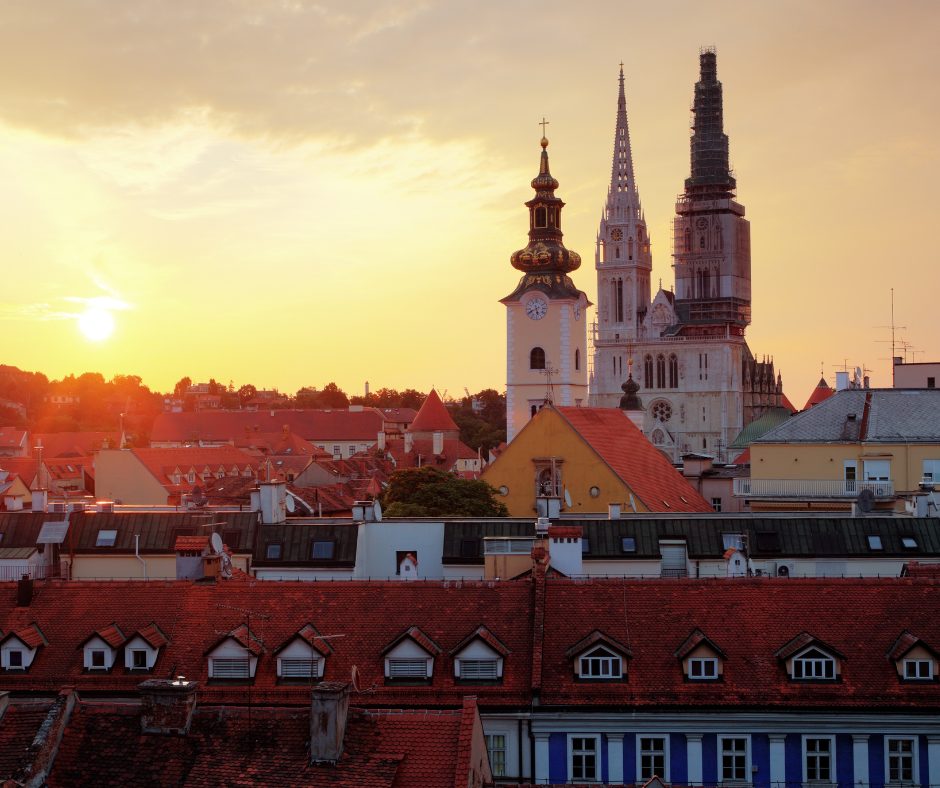 The impressive castle steeples stand in the forefront of the golden sunset, on a croatian rail holiday